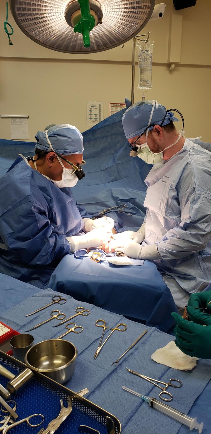 Medical team conducting surgery in Los Angeles hospital operating room.